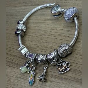 Original Pandora Bracelet, 925 Silver Ale. With assorted charms + Pandora bag.